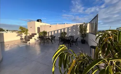a patio with tables and chairs on top of a building at Casa Estrellita-Romantic getaway in Santo Domingo