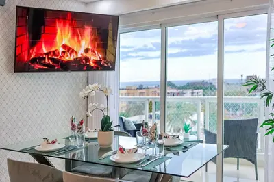 a dining room with a fireplace on the wall at Cozy City Center 2BD Condo, in Santo Domingo