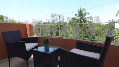 a balcony with chairs and a table on a balcony at Juan Dolio Near Beach, Pool Cozy Stay in Villas del Mar