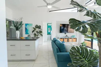 a living room with a blue couch and a tv at My luxury villa in Sosúa