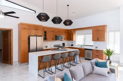 a living room with a couch and a kitchen at My luxury villa in Sosúa