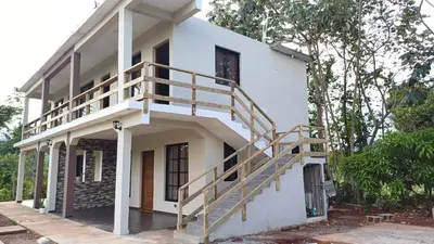 a white house with wooden stairs on it at Villa Sol de Campo in Las Galeras