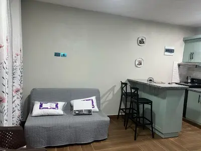 a living room with a couch and a kitchen at Villa Sol de Campo in Las Galeras