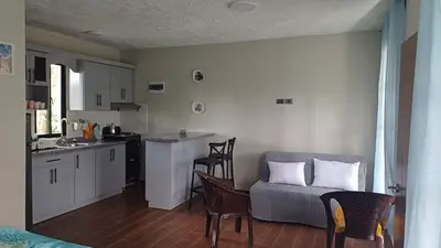 a kitchen with a couch and a table and chairs at Villa Sol de Campo in Las Galeras