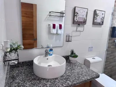 a white bathroom with a sink and a mirror at Villa Tropical Paradise Pool Rooftop in San Felipe de Puerto Plata