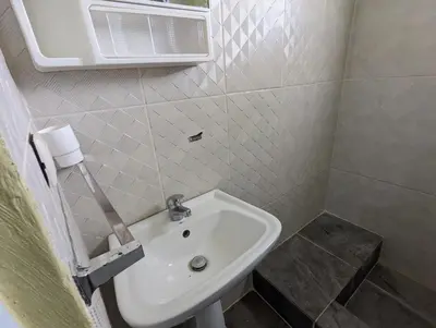 a white sink in a small bathroom with a window at Buenos Aires Apartments in Río San Juan