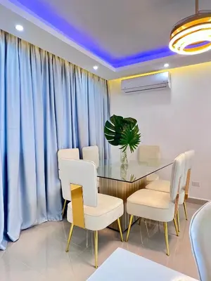 a dining room with a glass table and white chairs at Sky Golden in Los Altos de Jalisco