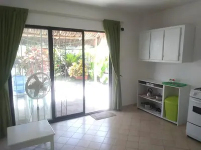 a kitchen with an open door to a patio at Surf & Stay Waveriders, Encuentro in Cabarete