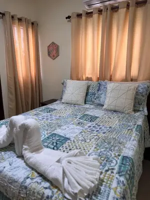 a bedroom with a bed with a quilt on it at Villa BayRum in San Felipe de Puerto Plata