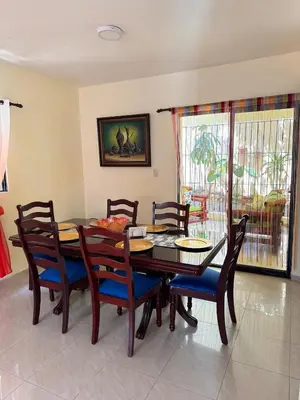 a dining room with a wooden table and chairs at Villa BayRum in San Felipe de Puerto Plata