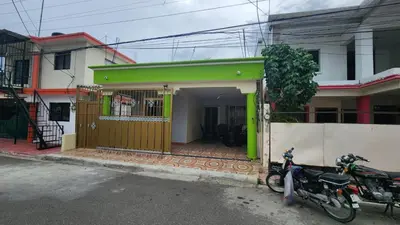 a motorcycle parked in front of a house at Airbnbbuenhogar in Concepción de La Vega