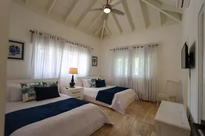 a bedroom with two beds and a ceiling fan at Villa en Casa de Campo 10127 in Colorado