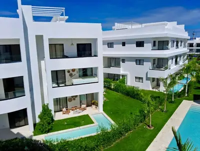 an aerial view of a white apartment building with a swimming pool at Casa Lulu in Punta Cana