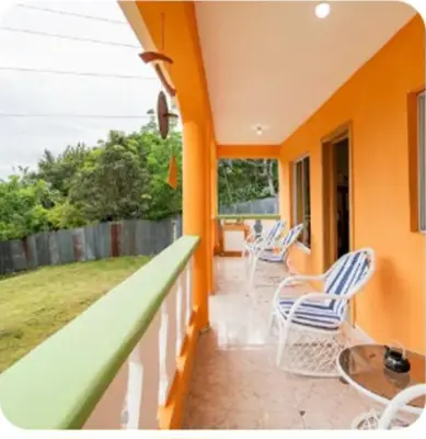 a balcony of a house with chairs and a table at paradise ranch san cristobal in San Cristóbal