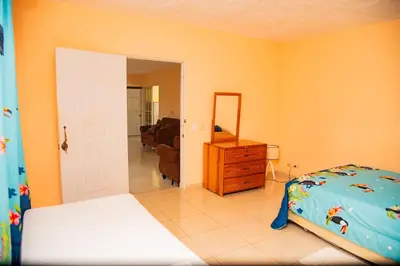a bedroom with a bed and a dresser and a mirror at Boom Ranch in Las Galeras