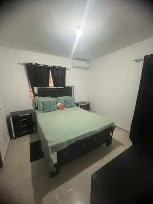 a bedroom with a large bed in a room at Tú hogar en ciudad Juan Bosch in Los Paredones