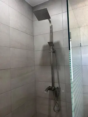 a shower with a shower head in a bathroom at Refugio Verde Las Terrenas in Las Terrenas