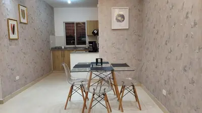 a kitchen with a table and chairs in a room at Modern and Luxury apartment in La Grúa