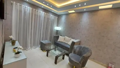 a living room with a chair and a desk at Modern and Luxury apartment in La Grúa