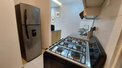 a kitchen with a stove and a refrigerator at Modern and Luxury apartment in La Grúa