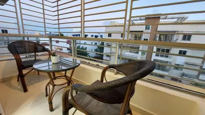 a balcony with two chairs and a table in front of a window at Modern and Luxury apartment in La Grúa