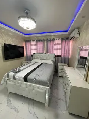 a bedroom with a large bed and a tv at Apartamento 2 in Cancino