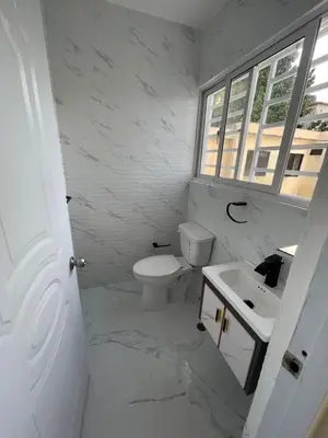 a white bathroom with a sink and a toilet at Apartamento 2 in Cancino