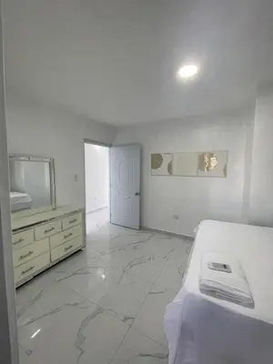 a white room with a bed and a television at Apartamento 2 in Cancino