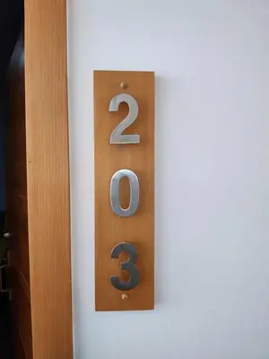 a wooden number on a white wall at Sunflower Bayahibe with pool in Bayahibe