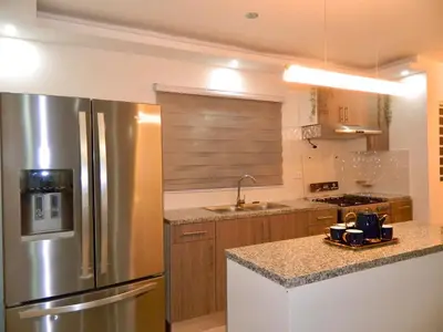 a kitchen with a stainless steel refrigerator and a sink at The Chic Hideout full apt in san isidro Terrace in Juan López