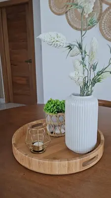 a white vase on a wooden tray with two plants at Paradise Escape Villa 201 2br Private Pool in Punta Cana