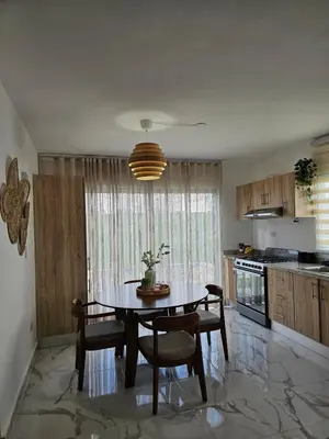a kitchen with a table and chairs in a room at Paradise Escape Villa 201 2br Private Pool in Punta Cana
