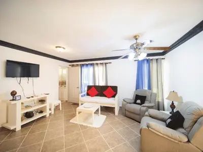 a living room with two couches and a tv at Garden Condos 7 - Central Apartment in Strip in Sosúa