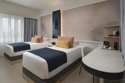 a hotel room with two beds and a table at Royal Beach Hotel Punta Cana, A JdV by Hyatt in Punta Cana
