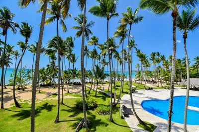 a view of a resort with palm trees and a pool at Coson Bay in Las Terrenas