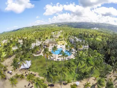 an aerial view of the resort with a pool and palm trees at Coson Bay in Las Terrenas