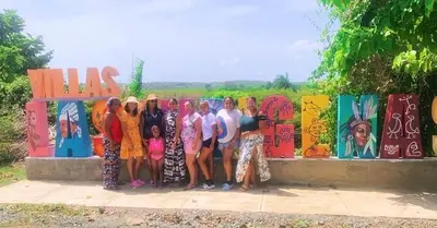 a group of people standing in front of a wall at Villas Las Indigenas in Imbert