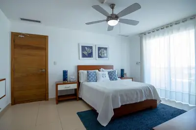 a bedroom with a bed and a ceiling fan at Condominio Marbella Juan Dolio in Villas del Mar