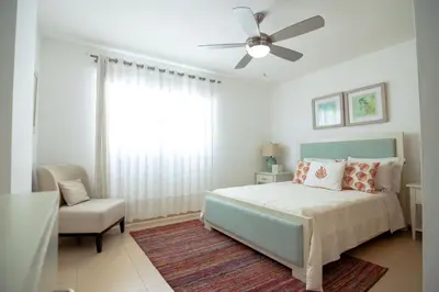 a bedroom with a bed and a ceiling fan at Condominio Marbella Juan Dolio in Villas del Mar
