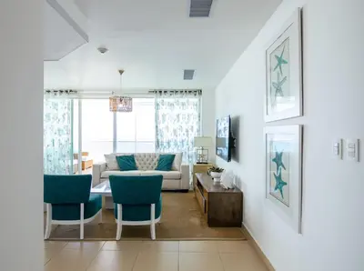 a living room with a couch and a table and chairs at Condominio Marbella Juan Dolio in Villas del Mar