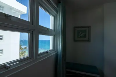 a window in a room with a view of the ocean at Condominio Marbella Juan Dolio in Villas del Mar
