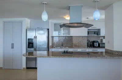 a kitchen with a refrigerator and a counter top at Condominio Marbella Juan Dolio in Villas del Mar