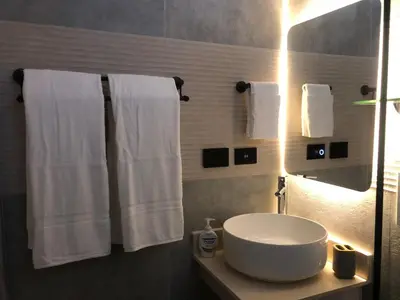a bathroom with a white sink and towels at Cozy 2 bedroom Beach Apto in Bayahibe