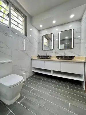 a bathroom with two sinks and a toilet at magnifica villa en cabrera in Cabrera