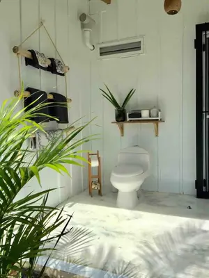 a bathroom with a toilet and plants in it at JAVO BEACH the Nest in Las Galeras