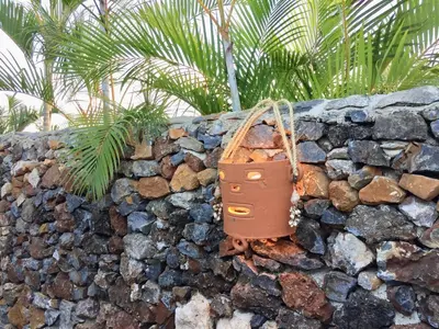 a purse hanging on a stone wall at JAVO BEACH the Nest in Las Galeras