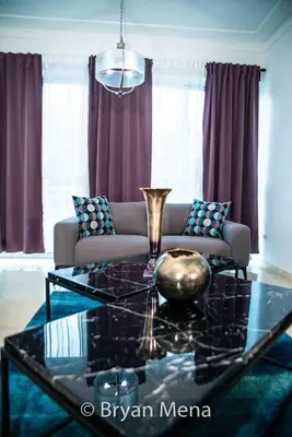 a living room with a couch and a glass table at Eclectic gorgeous, modern 3 levels penthouse in Santo Domingo