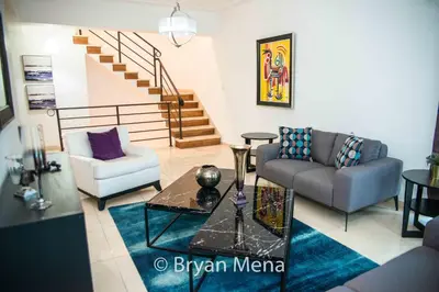 a living room with two couches and a staircase at Eclectic gorgeous, modern 3 levels penthouse in Santo Domingo