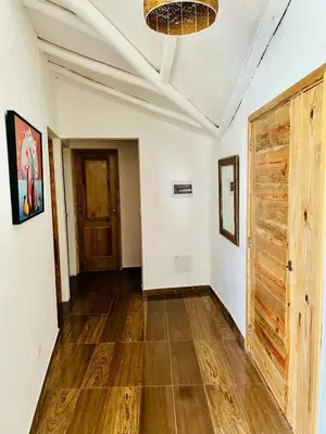 an empty room with a wooden floor and a door at The Coco Garden Cabin in Las Galeras