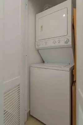 a white washer and dryer in a small room at Escape Beachfront Condo Costa del Sol Juan Dolio in Los Corrales